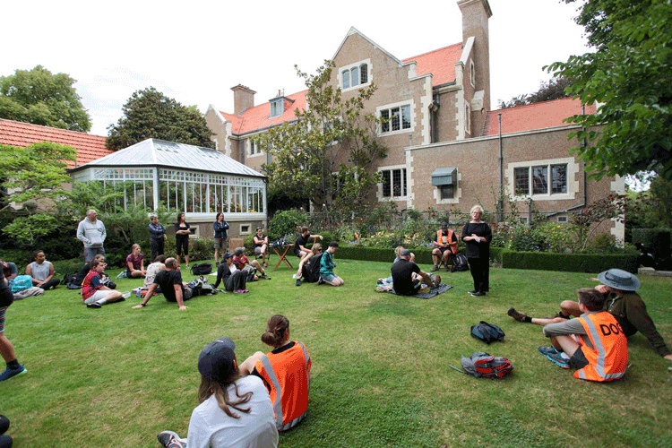 People in a garden having a meeting